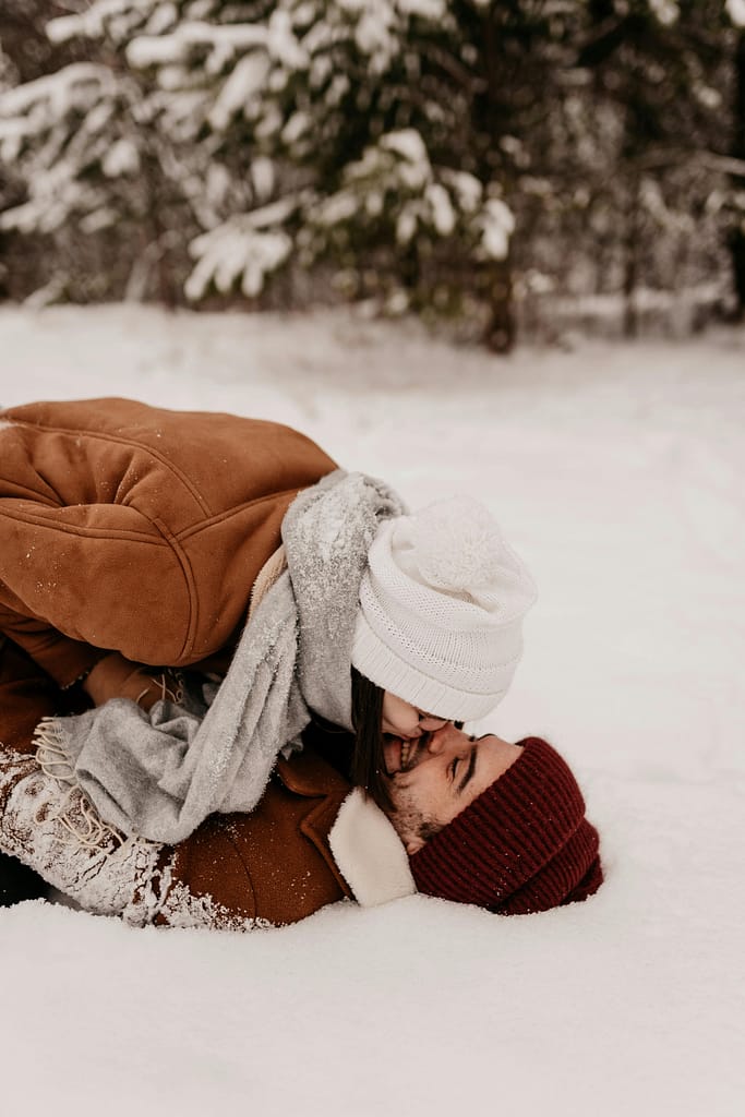 Holiday Reading a man and woman kissing in the snow 
